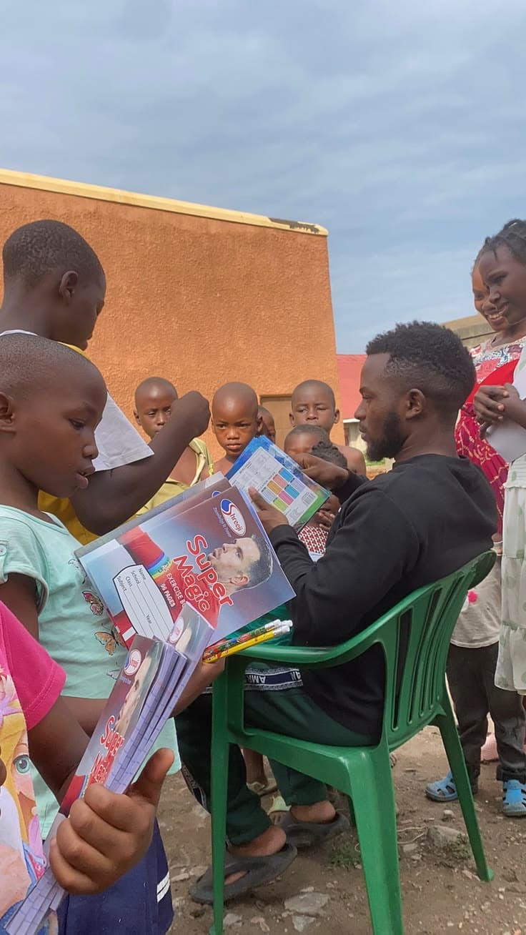 Children receiving school supplies and hygiene kits with dignity